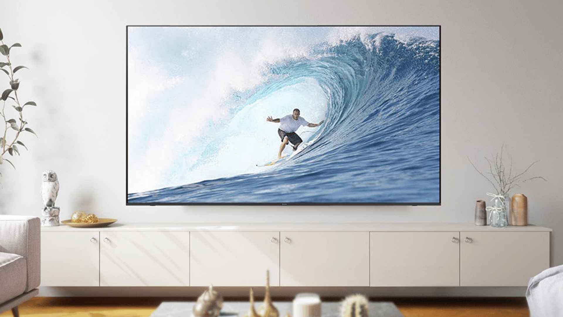 Panasonic 4K Mini LED TV displaying a surfing scene in a bright living room.