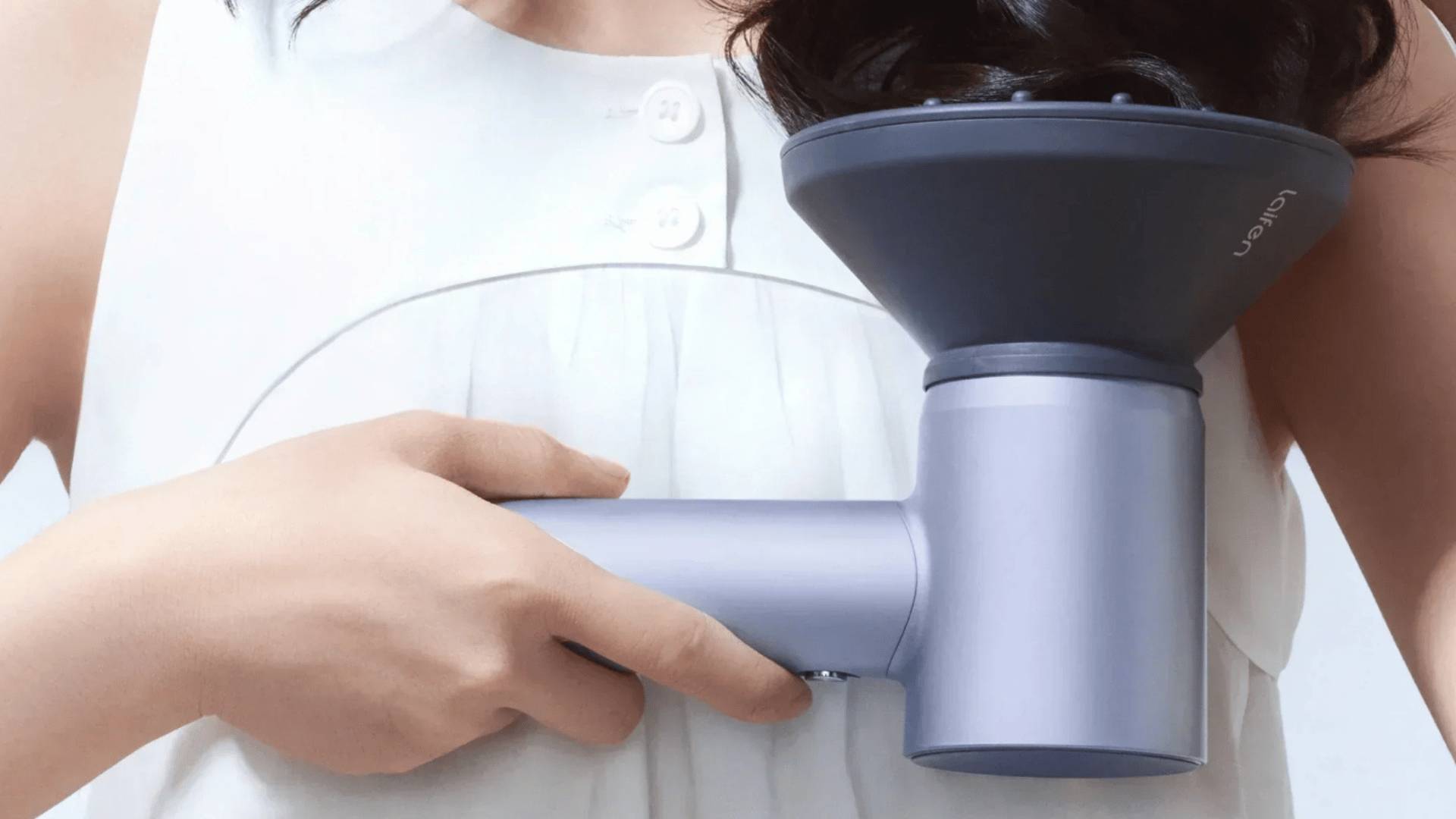 Person holding a Laifen hair dryer with a diffuser attached.