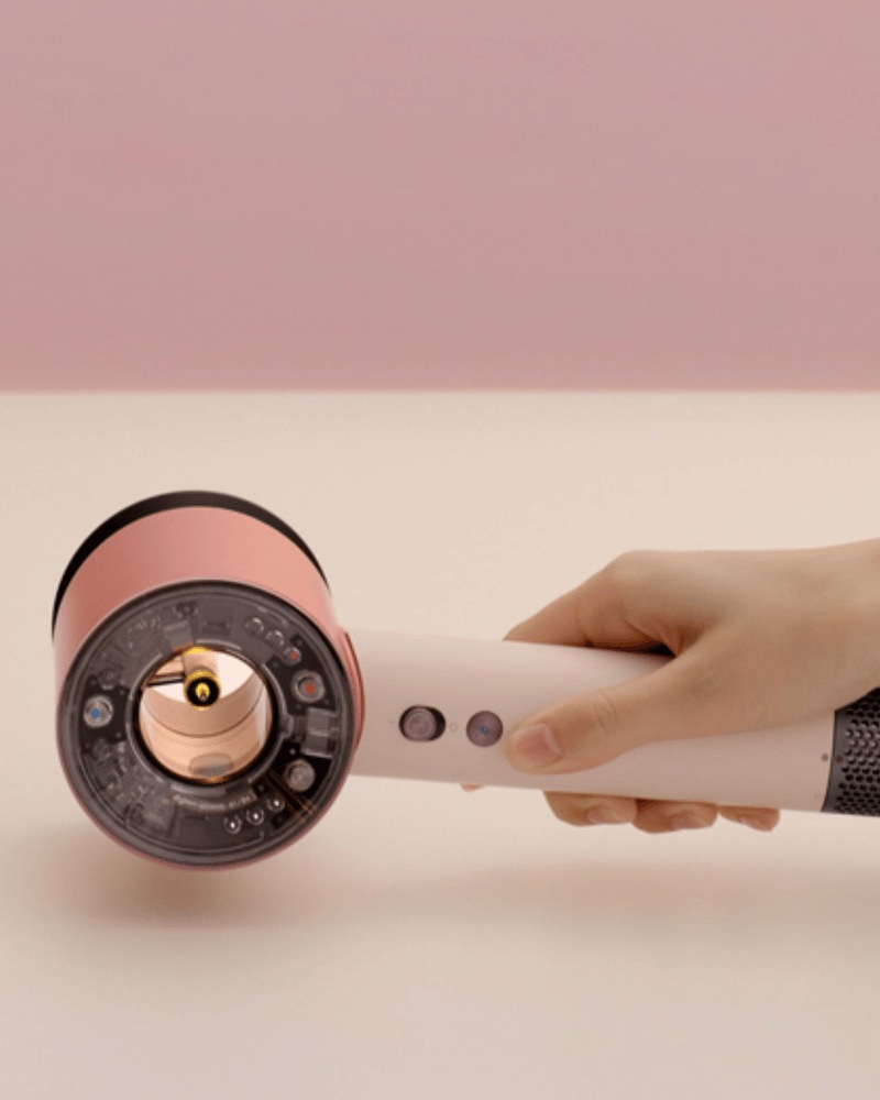 Dyson Supersonic Nural hair dryer held in hand.