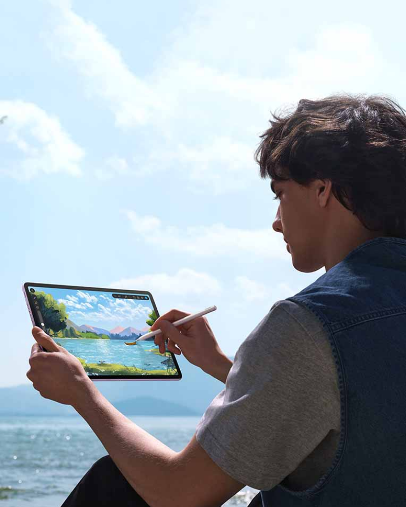 Promotional image for the Huawei Tablet Series showing a person using a stylus to draw on a tablet outdoors, highlighting on-the-go productivity with PC-level performance