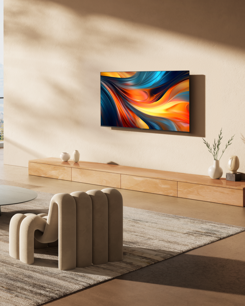 A modern living room setup showcasing a wall-mounted TV with vibrant abstract colors, used to highlight home entertainment or interior design aesthetics.