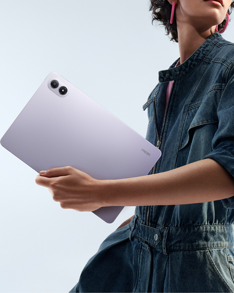 A promotional image featuring a person holding a Xiaomi tablet in a sleek purple finish, highlighting its modern design and the tagline “Fun to the Max.”