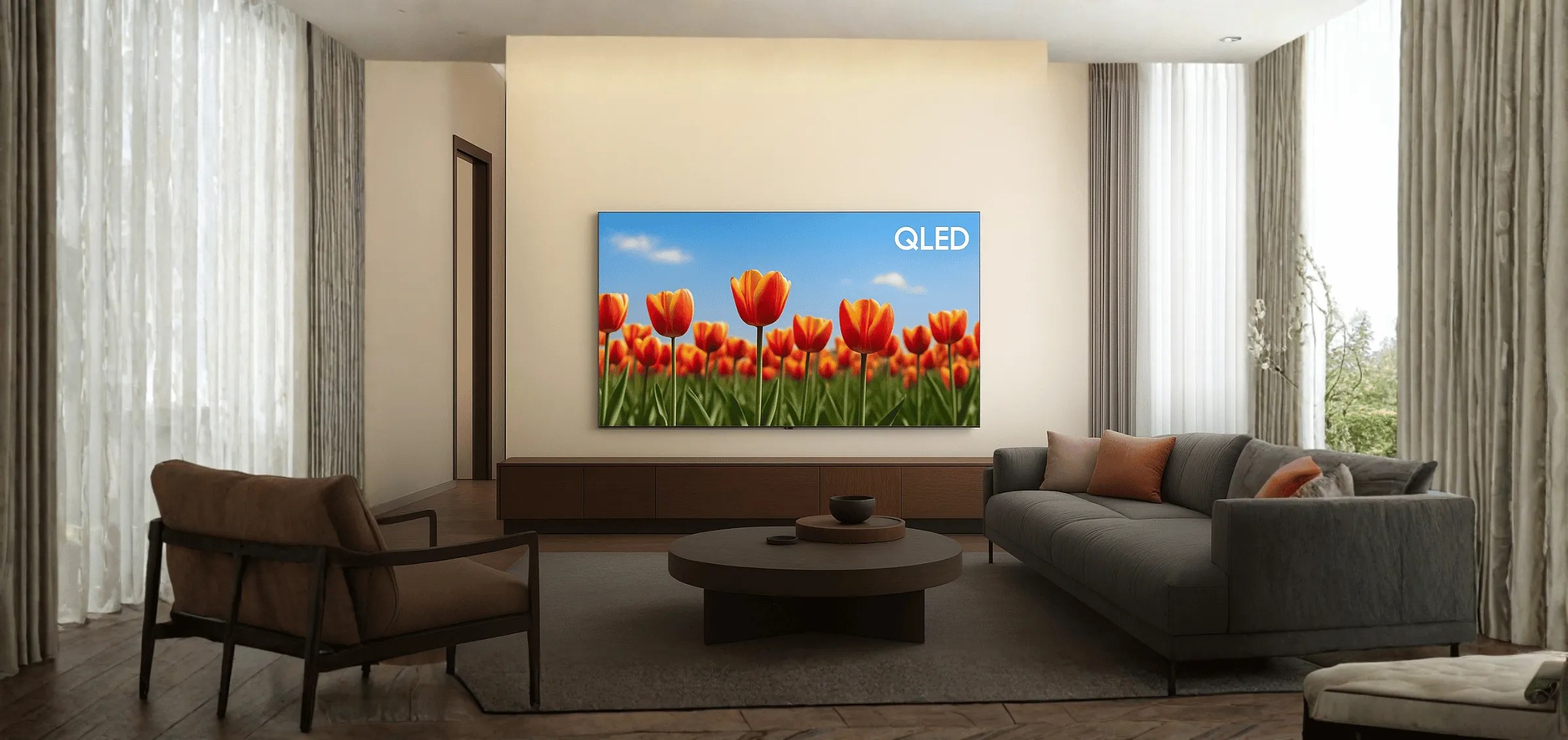 QLED TV in a bright modern living room, tulip field image on screen representing high brightness and rich quantum dot colour performance.