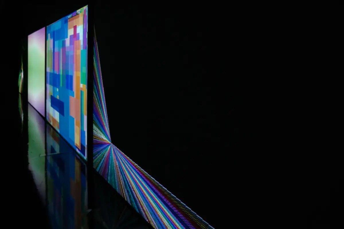 Ultra-thin screens displaying vibrant colors in a dark room. Discover the smart viewing revolution of AI TV.