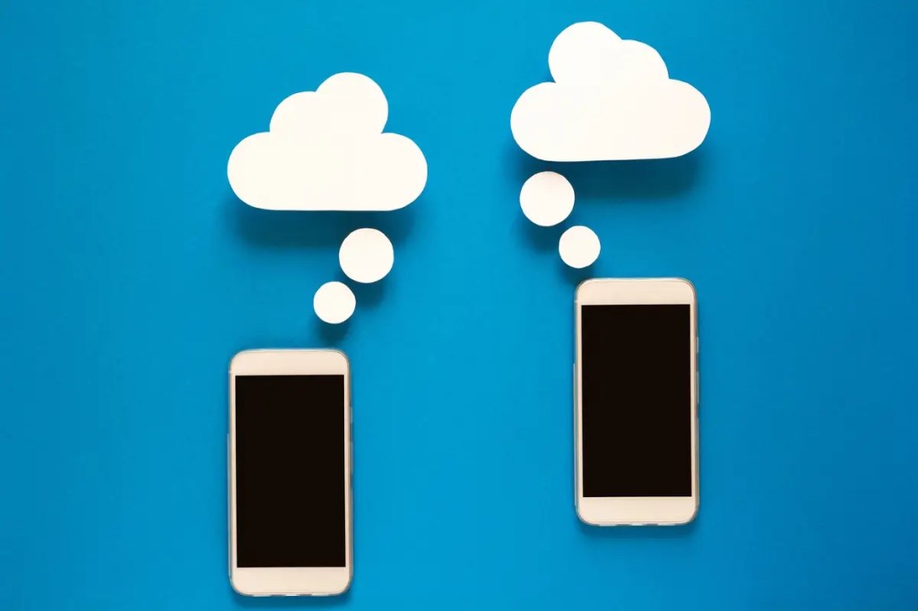 Two phones with paper cloud thought bubbles on blue. Guide to transferring data to a new iPhone or Android phone.